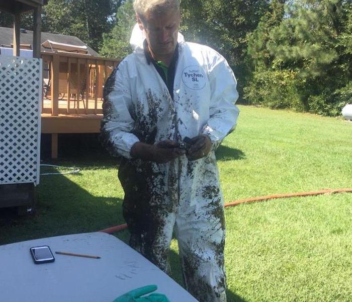 Image of a person with dirty protective clothes after inspecting a crawl space
