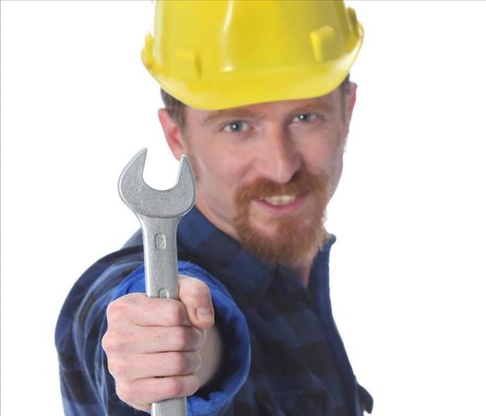 Worker holding a wrench.