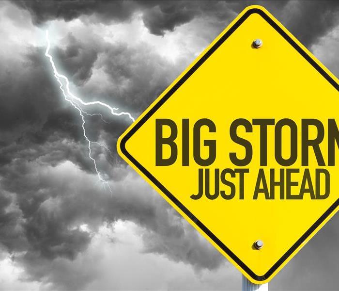 Image of a street sign stating "big storm just ahead"